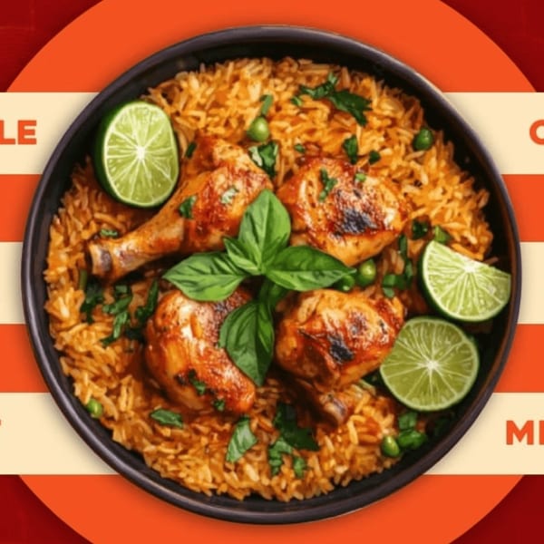 Maharaja Indian Restaurant's chicken biryani, garnished with fresh basil and lime wedges.